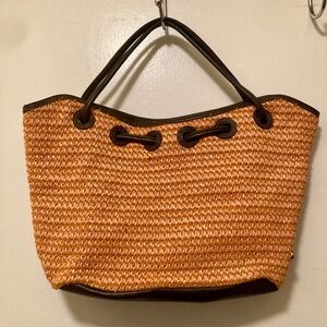 Stylish woven handbag with decorative beads.